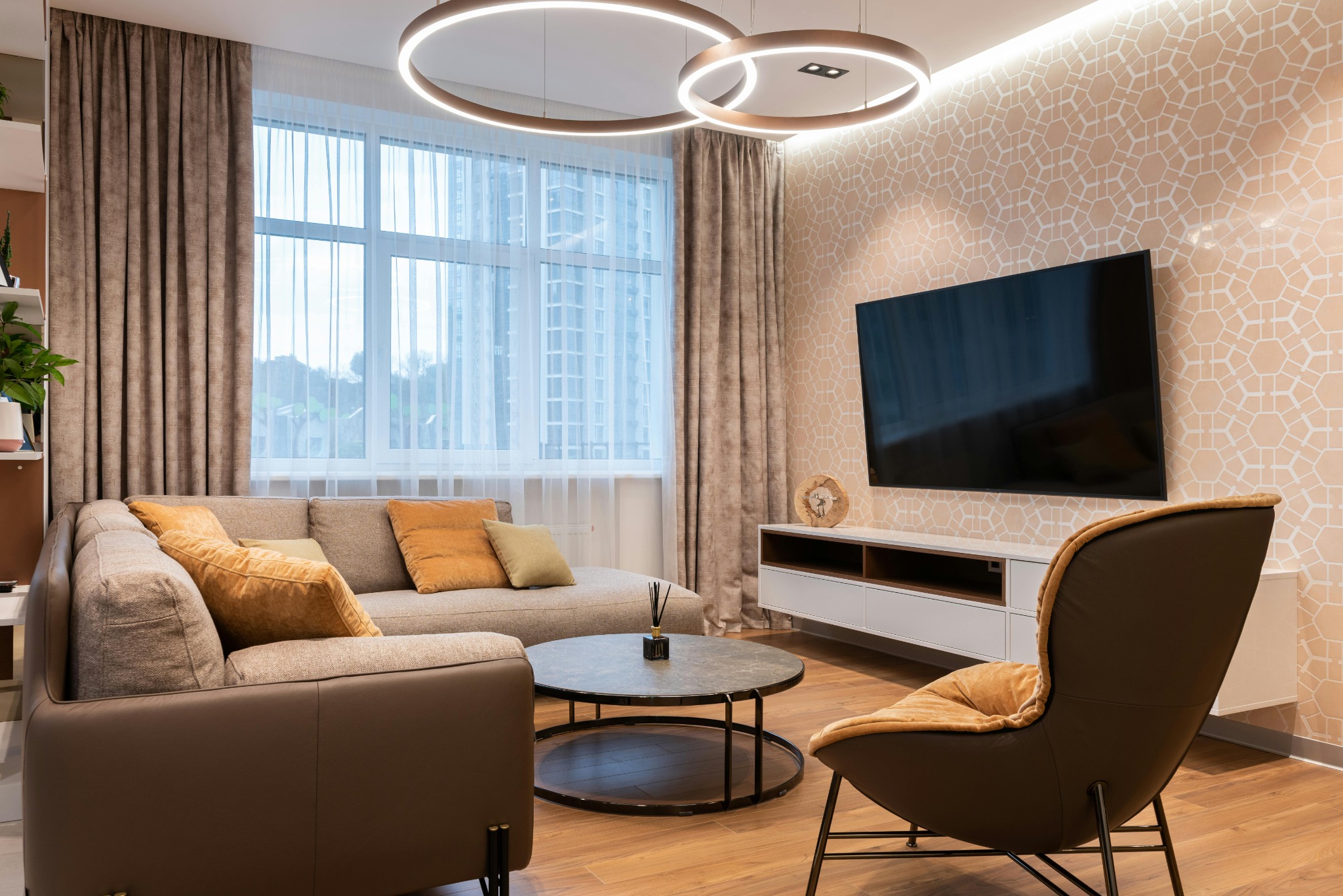 Elegant living room installation with wall-mounted TV, concealed cabling, and integrated smart lighting control.